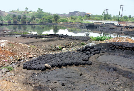 Blatantly flouting norms, SAIL Durgapur’s coke oven discharges hazardous tar waste, which people collect and use as cooking fuel; (right) Tata Steel discharges coal ash slurry into the Kharkai river in Jamshedpur