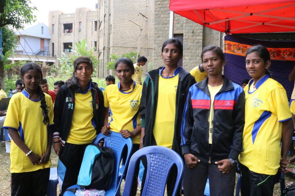 Marthal (second from right) coaches football to children from her slum