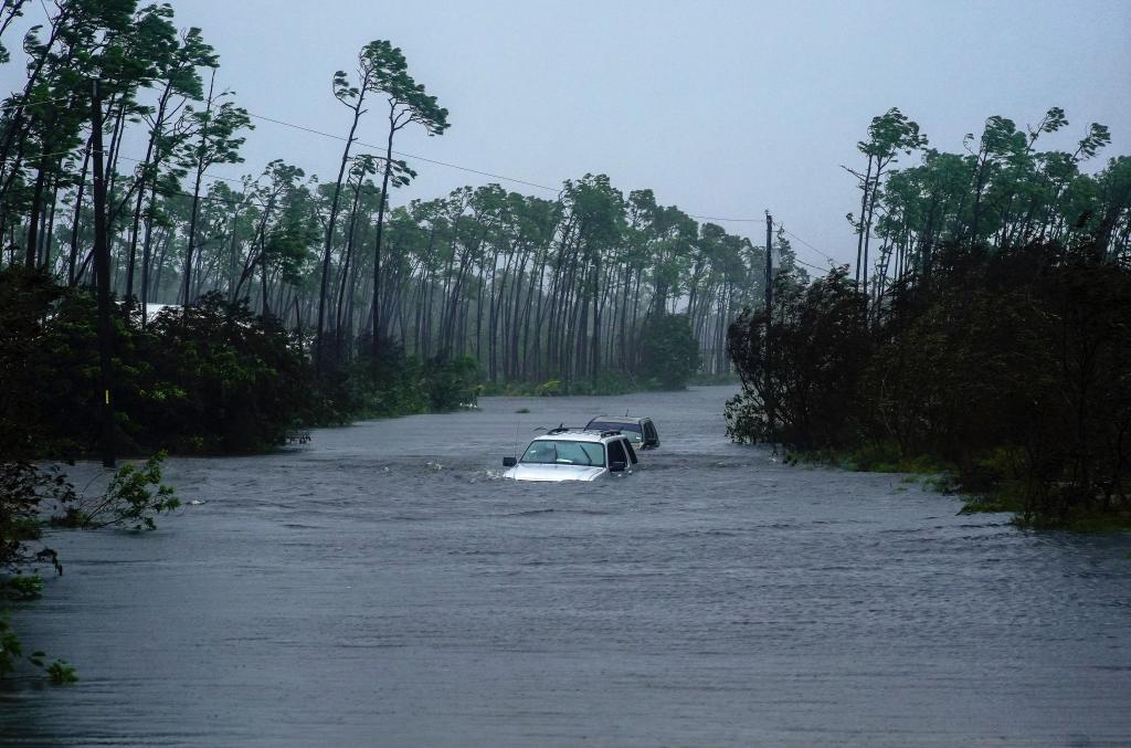 Cars sit submerged in water from Hurricane Dorian in Freeport, Bahamas. Photo: AP Photo/Ramon Espinosa