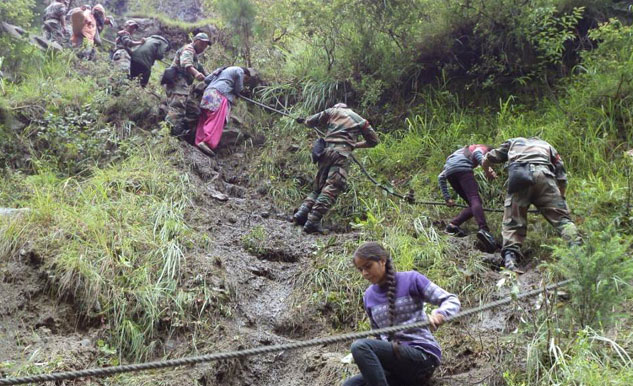 Army personanel evacuating pilgrims by foot on route to Kedarnath