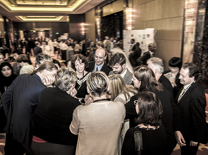 Delegates huddle outside the plenary room on the last day of MOP 27  Credit: IISD